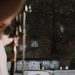 Focused archer aims at colorful targets in an outdoor forest range.